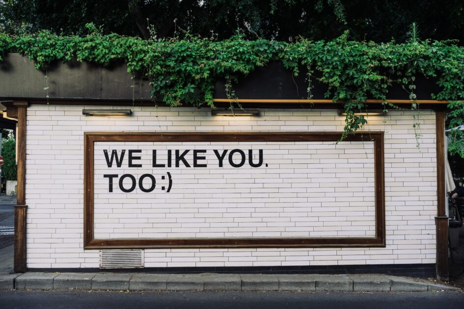 Store sign/side of building that says "We Like You Too"