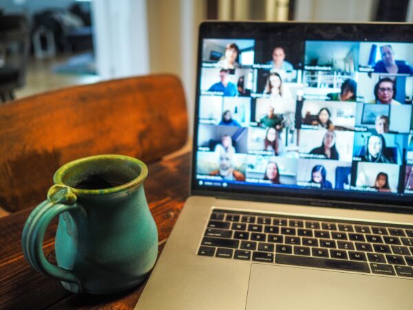 Ceramic coffee mug next to zoom meeting